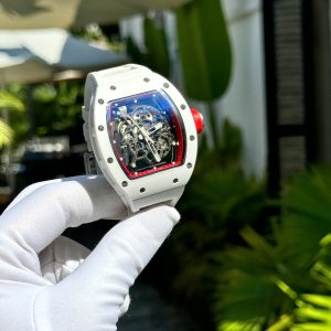 a hand wearing a glove holding a watch